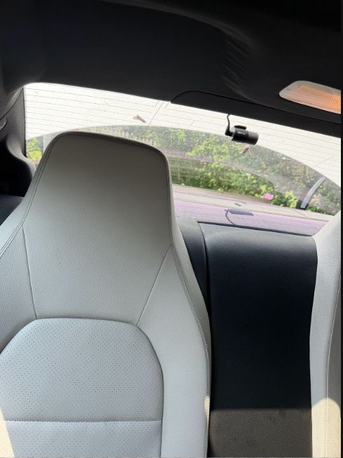 Rear dash camera installation with cable routed near the vehicle headliner