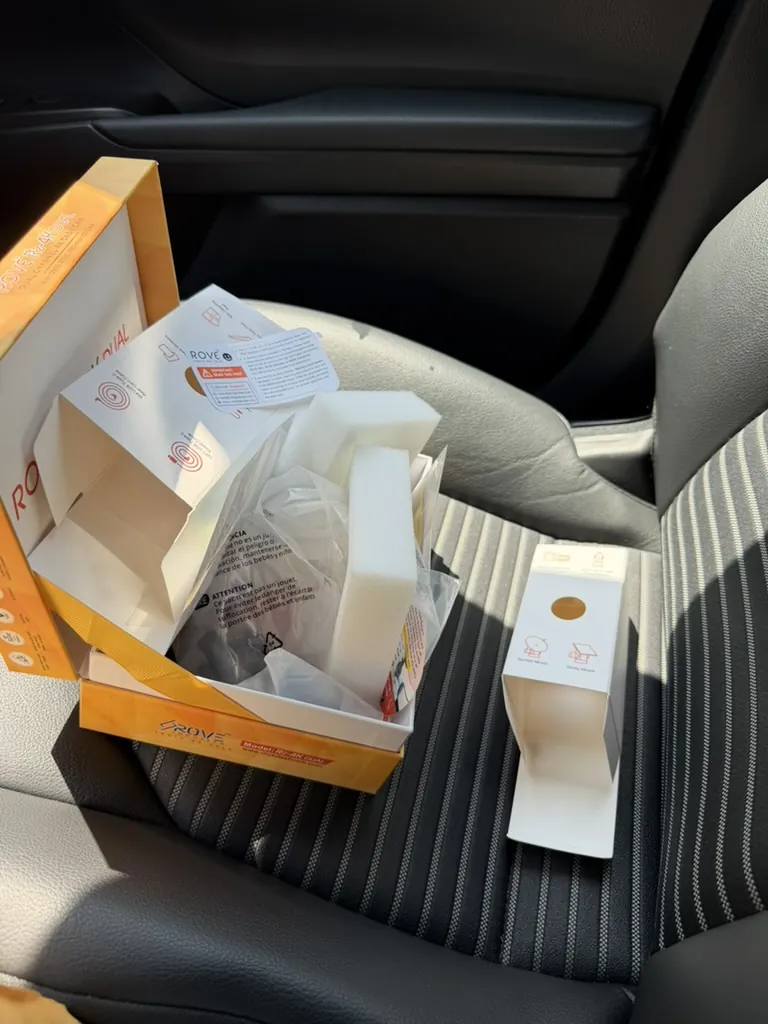 ROVE dashcam packaging and accessories on the Toyota Camry passenger seat