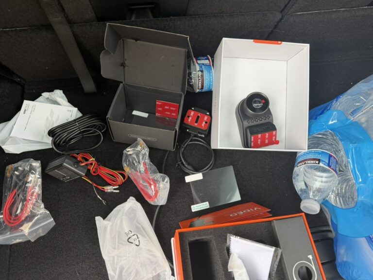 Vantrue camera packaging, cables and installation accessories laid out in the Dodge Durango cargo area.